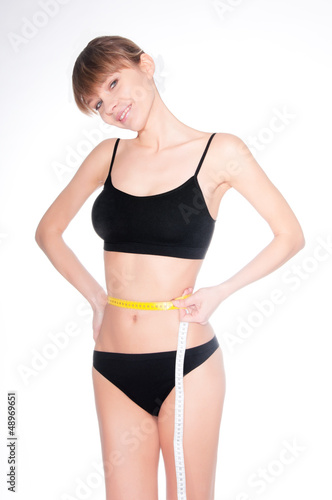 Beautiful sporty woman body with yellow measure on white backgro