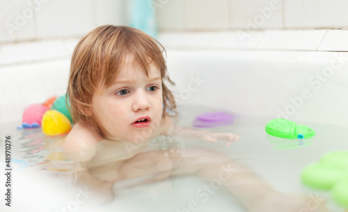  baby girl bathes with toys