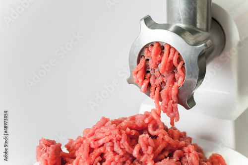 Mincer machine with fresh chopped meat photo