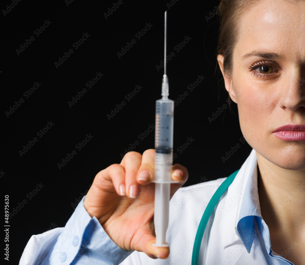 Closeup on medical doctor woman holding syringe Closeup on medical doctor woman holding syringe