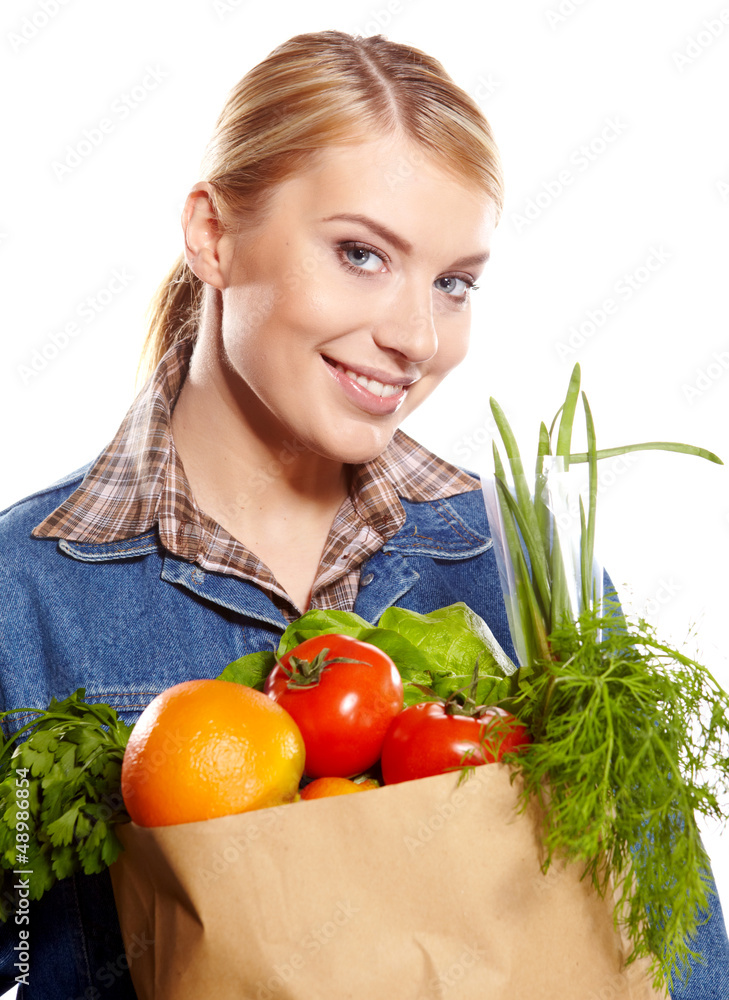 Portrait of happy young woman holding a shopping bag full of gro Portrait of happy young woman holding a shopping bag full of gro