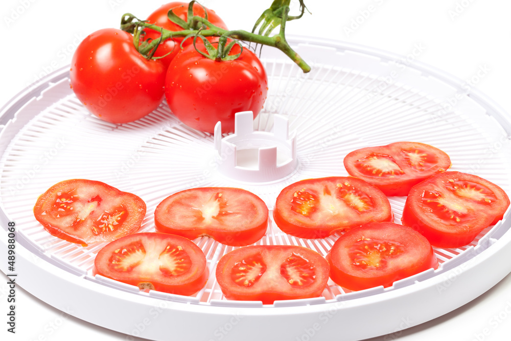 Fototapeta premium Ripe tomato on food dehydrator tray