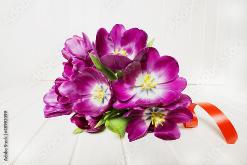 Fototapeta Naklejka Na Ścianę i Meble -  bunch of purple tulips on a white table