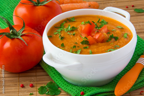 Vegetable cream soup with parsnip, carrots and tomatoes