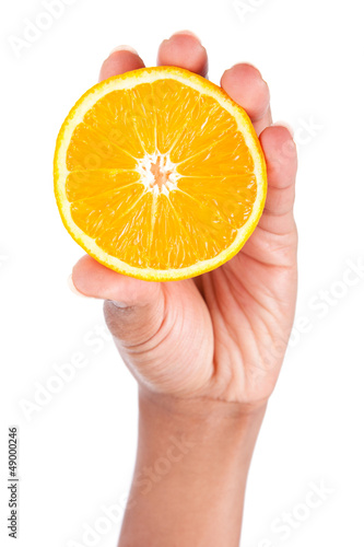African American hand holding an orange slice