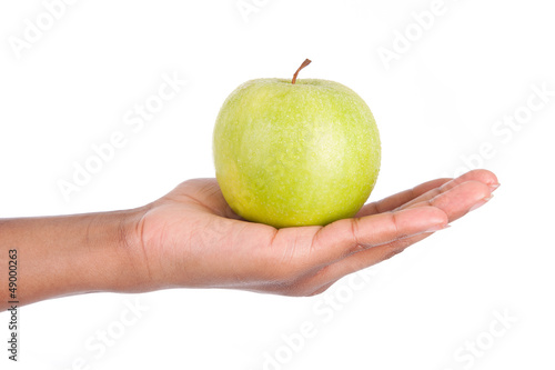 African American woman holding a fresh apple in her hand