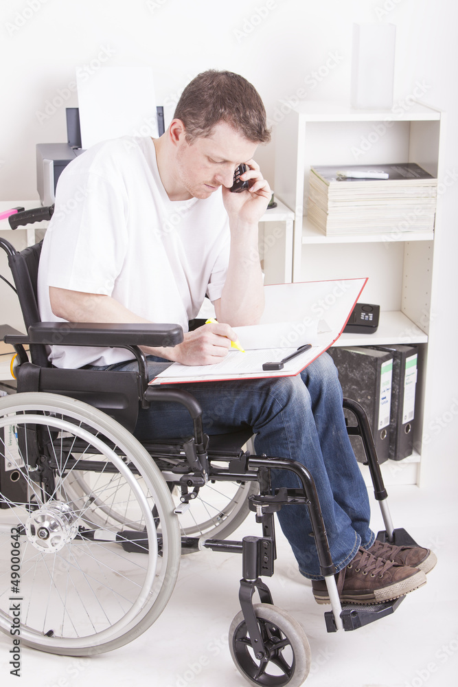 Man in wheelchair at work Man in wheelchair at work