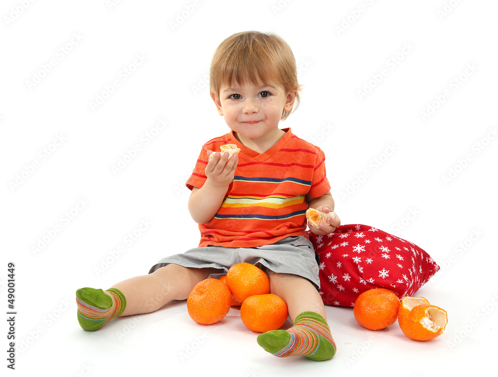 cute little boy eating tangerines, isolated on white cute little boy eating tangerines, isolated on white