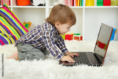 cute little boy and noteboo...