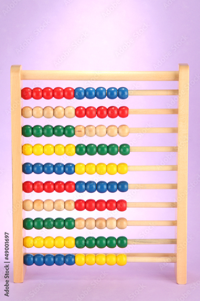 Bright wooden toy abacus, on purple background Bright wooden toy abacus, on purple background
