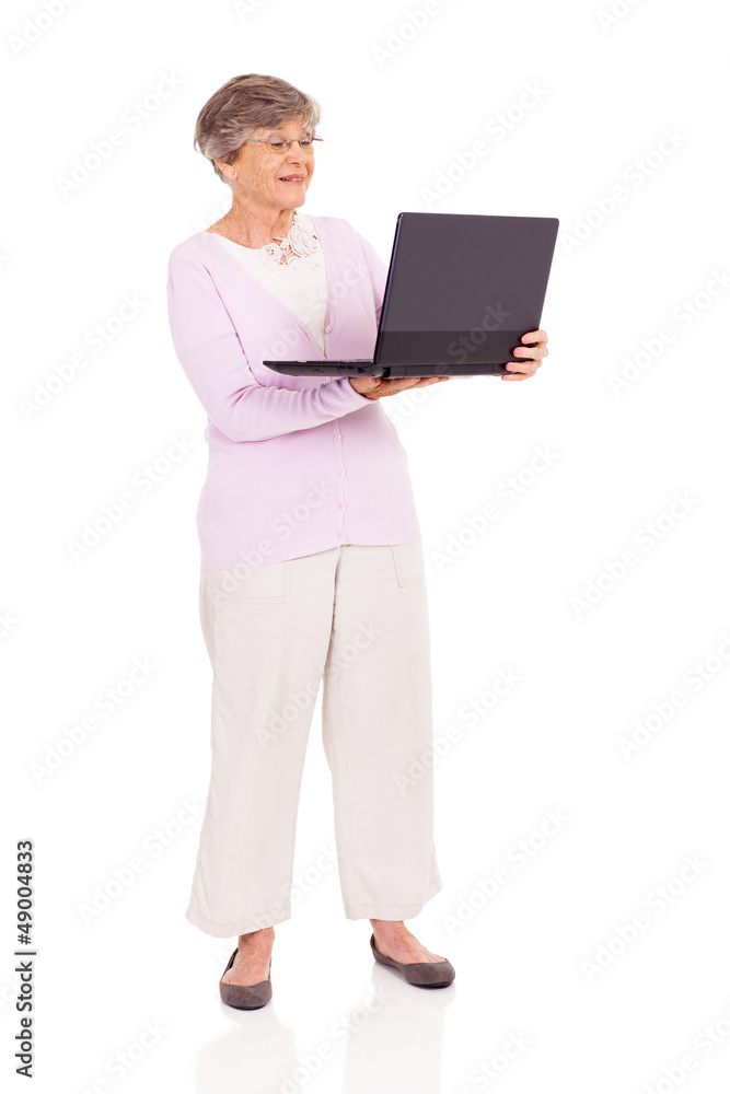 senior woman using laptop computer isolated on white senior woman using laptop computer isolated on white