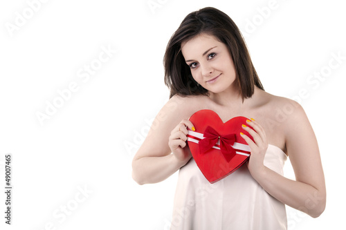 Beautiful girl with a heart shape in her hands isolated on white © DC Studio