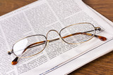glasses on a newspaper