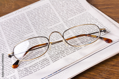 glasses on a newspaper