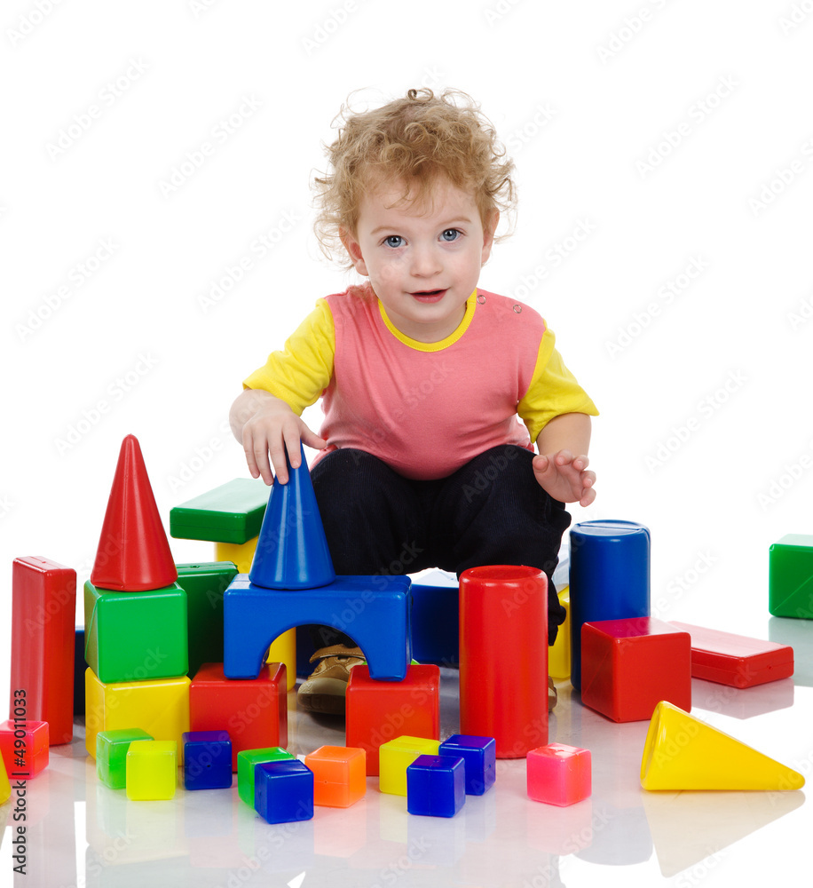 boy build from plastic blocks. Isolated on white boy build from plastic blocks. Isolated on white