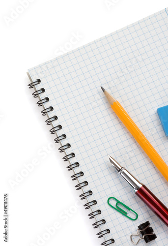school supplies on checked notebook