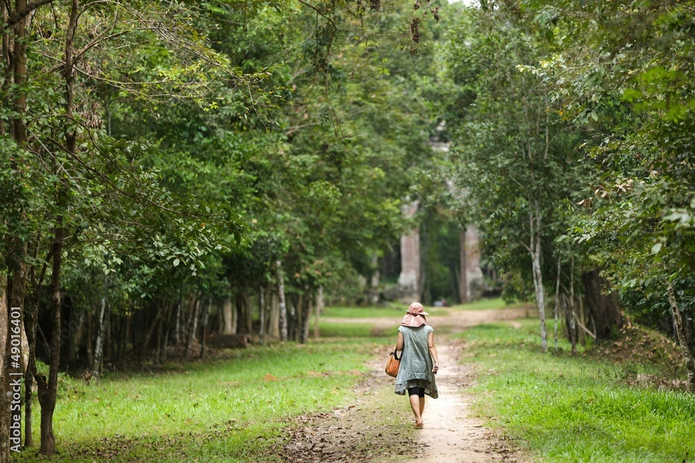 Fototapeta premium Woman walking in forest