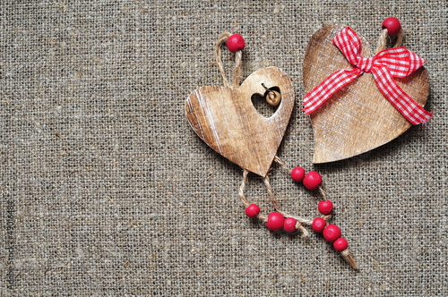 Wooden hearts on fabric background