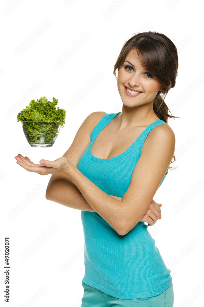 Light food concept. Smiling woman balancing lettuce Light food concept. Smiling woman balancing lettuce