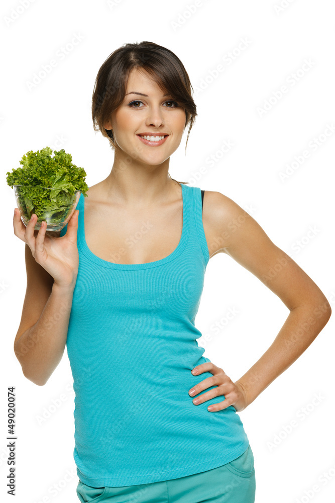 Smiling woman holding lettuce leaves in transparent bowl Smiling woman holding lettuce leaves in transparent bowl