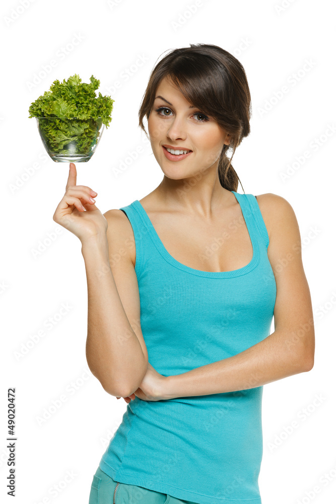 Light food concept. Woman balancing bowl with salad on finger Light food concept. Woman balancing bowl with salad on finger