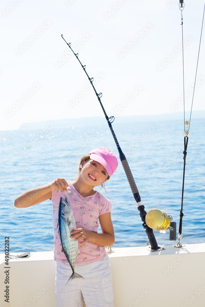 child little girl fishing in boat holding little tunny fish catc child little girl fishing in boat holding little tunny fish catc