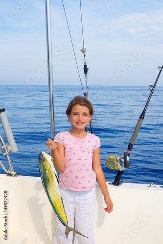 child girl fishing in boat with mahi mahi dorado fish catch