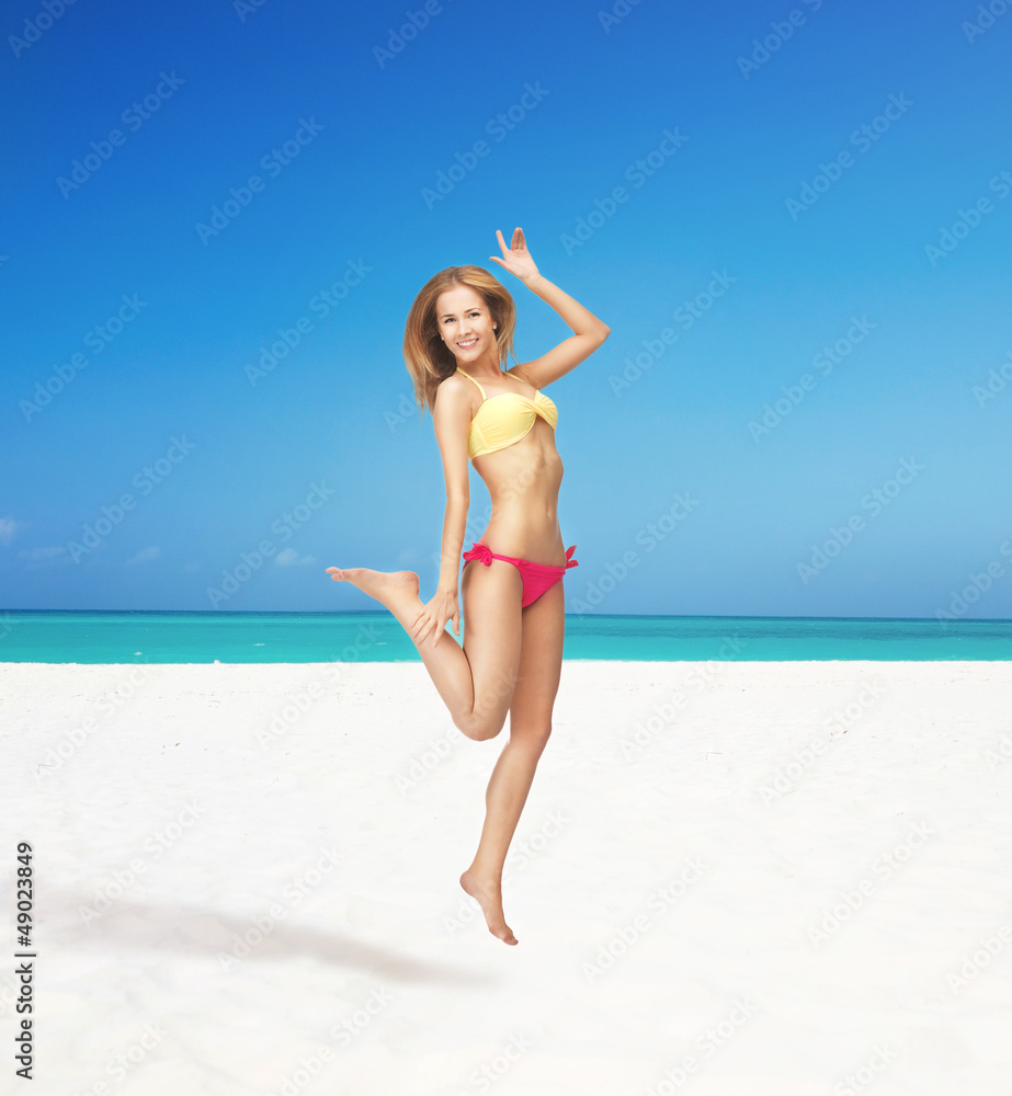 happy jumping woman on the beach