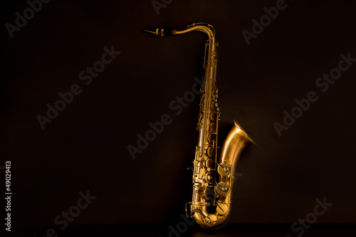 Sax golden tenor saxophone in black photo