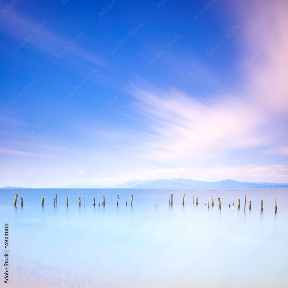 Poles and soft water on sea landscape. Long exposure. Poles and soft water on sea landscape. Long exposure.
