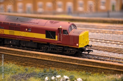 Red and yellow weathered model train diesel engine