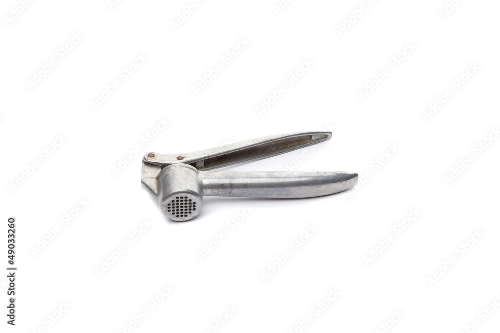 Metal masher on garlic isolated on white background Metal masher on garlic isolated on white background
