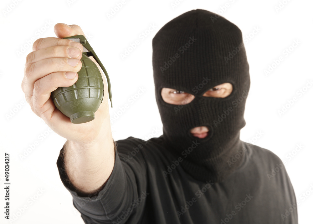 Masked man bomber aims with hand grenade Masked man bomber aims with hand grenade