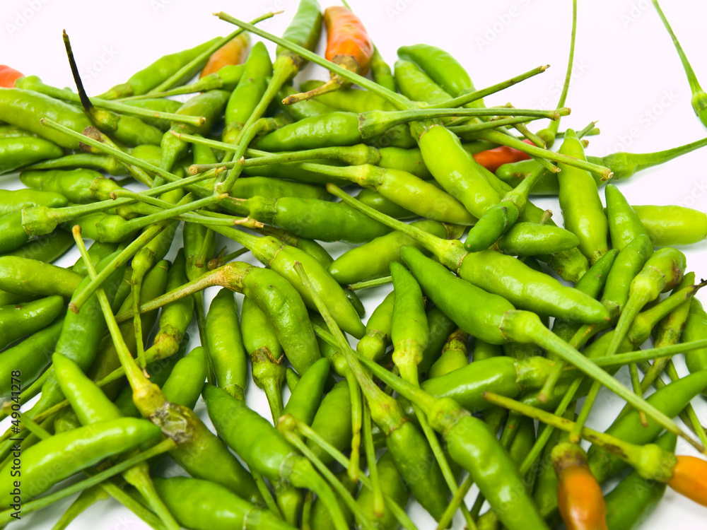 Green birds eye chillies pile from Thailand Green birds eye chillies pile from Thailand