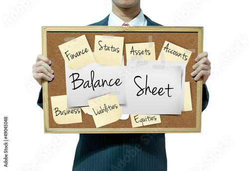 Business man holding board on the background, Balance Sheet photo