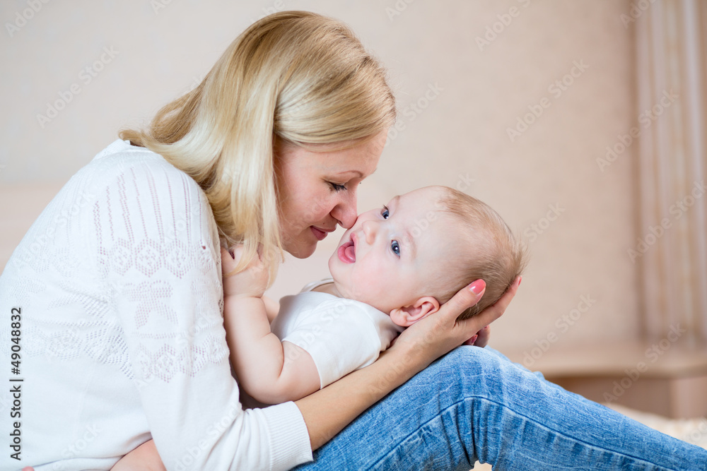 mother playing with baby boy indoors mother playing with baby boy indoors