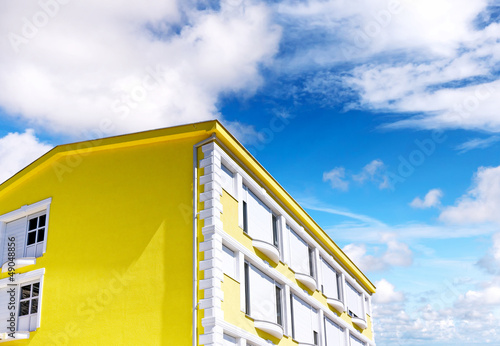 Sunny house on blue sky