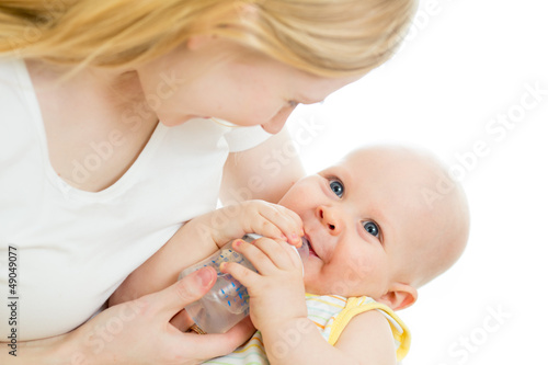 mother feeding from bottle her adorable baby boy