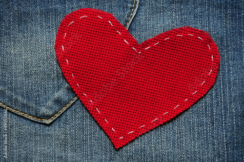 Jeans background with red heart photo