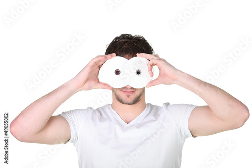 young man hiding his face behind a mask