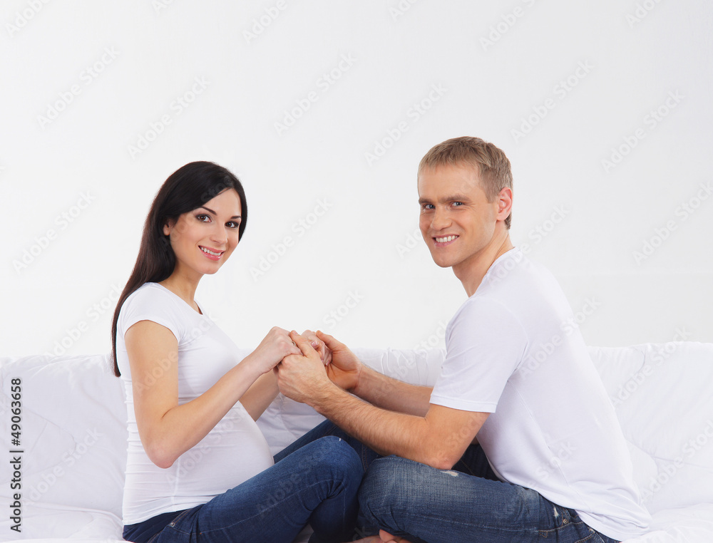 A lovely Caucasian couple preparing together for the baby A lovely Caucasian couple preparing together for the baby