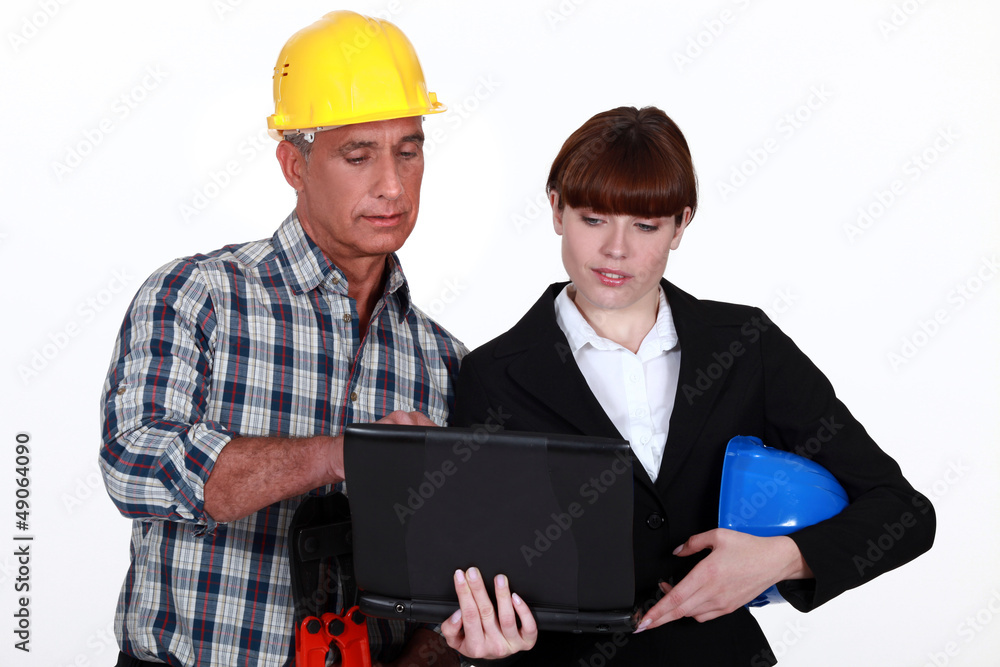 Architect and builder with a laptop Architect and builder with a laptop