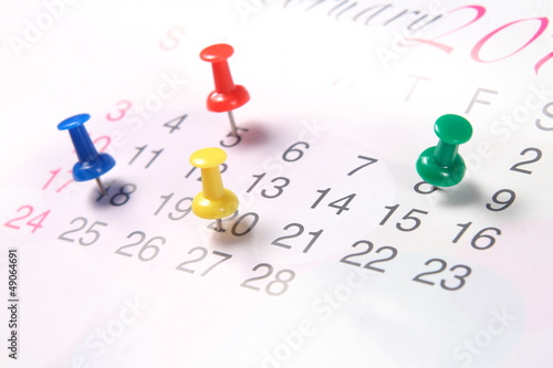 Closeup calendar page with drawing-pins