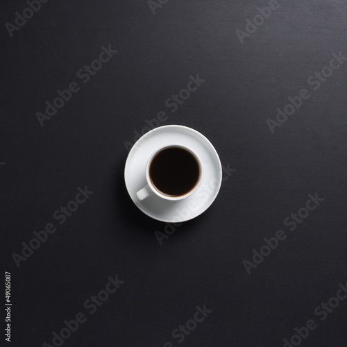 A cup of fresh coffee on a black table background