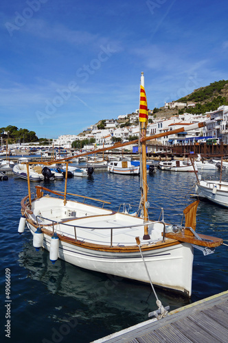 Typical Catalan boat at dock in the marina of the Mediterranean village Puerto de la Selva, Costa Brava, Spain