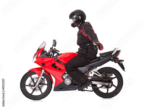 Biker standing up while riding his motorbike