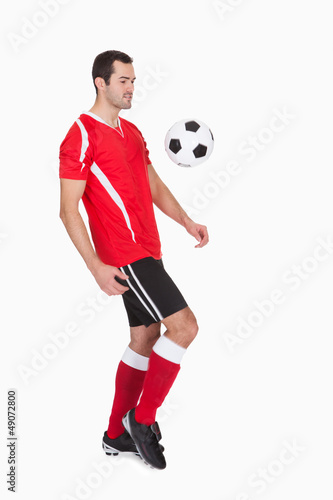 Professional soccer player kicking ball © Andrey Popov