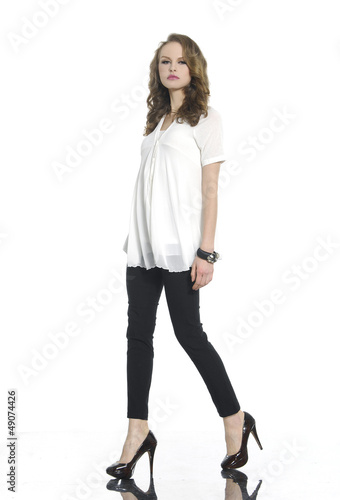 Full body young woman in casual clothes posing for the camer