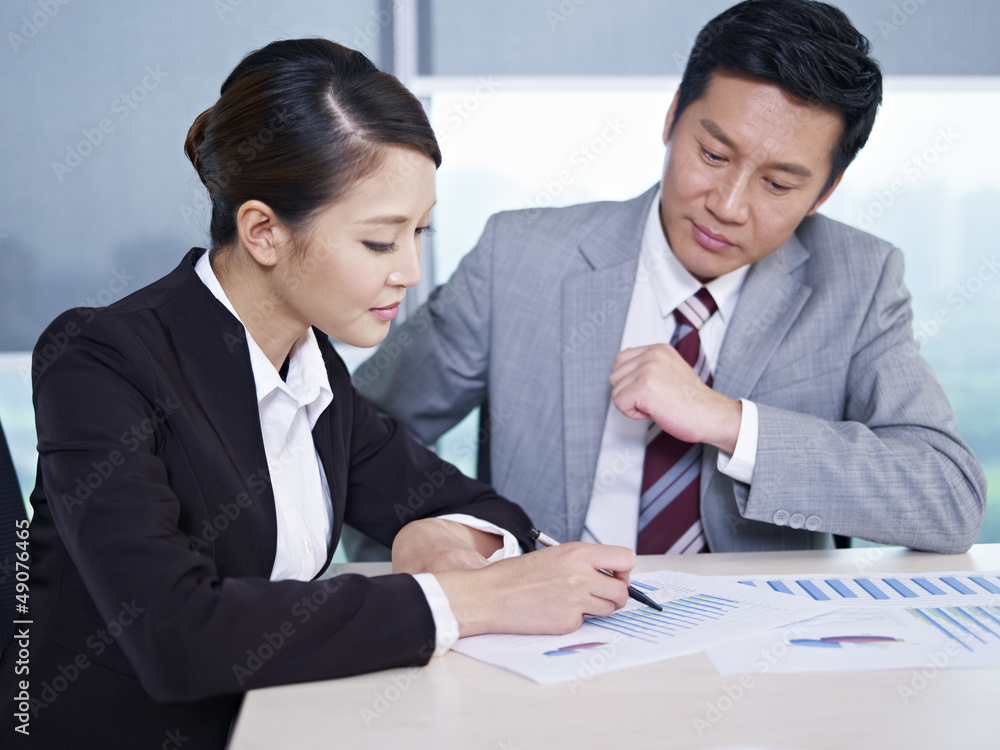 asian business people discussing sales performance asian business people discussing sales performance