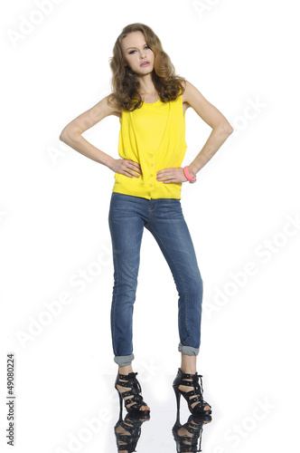 Full length portrait of a pretty young woman in jeans posing